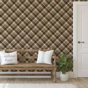 May include: A wooden bench with two white pillows, one with the text "welcome home". The background is a plaid pattern in shades of brown, green, and orange. A white door and a potted plant are also visible.