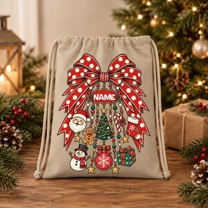 Può includere: Una borsa con coulisse beige caratterizzata da un grande fiocco rosso a pois bianchi. Dal fiocco pendono ornamenti tra cui Babbo Natale, un omino di pan di zenzero, un pupazzo di neve, un albero di Natale, un bastoncino di zucchero, una calza e un regalo con il testo NAME.