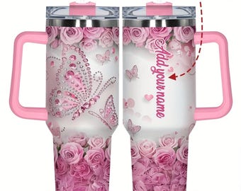 May include: A stainless steel tumbler with a handle, featuring a pink rose pattern at the top and bottom, butterfly graphics with pink rhinestone accents, and a clear lid with a straw. The back includes the text Add your name and YOUR NAME HERE.