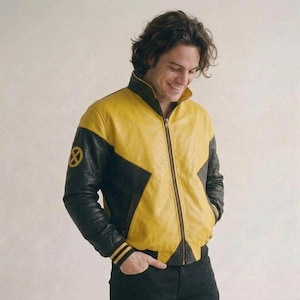 May include: A yellow and black leather jacket featuring a high collar, a full-length front zipper, and ribbed cuffs with two yellow stripes. The right sleeve displays a circular yellow and black X-Men logo emblem on the upper arm area.