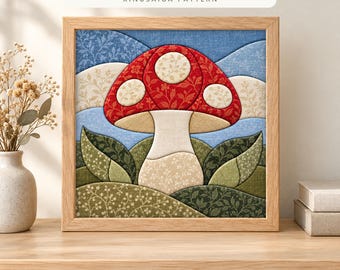 May include: A square framed Kinusaiga pattern art piece featuring a red and cream toadstool mushroom with floral fabric textures, set against a blue sky and green rolling hills. The text reads TOADSTOOL MUSHROOM KINUSAIGA PATTERN.