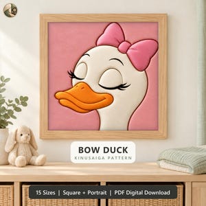 May include: A framed square wall art piece featuring a cartoon duck with a pink bow on its head, closed eyes, and an orange beak against a pink background. The text below reads BOW DUCK KINUSAIGA PATTERN, 15 Sizes, Square + Portrait, PDF Digital Download.