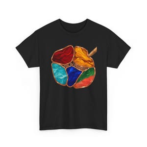 May include: A black t-shirt featuring a central graphic of a stained-glass style design with copper-colored outlines. The design consists of red, yellow, light blue, dark blue, green, and orange segments with the text FOIL IN PROGRESS.