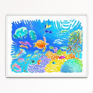 May include: A colorful illustration of an underwater scene with coral reefs, fish, and a sea turtle. The artwork is framed in a white frame and hangs on a white wall.