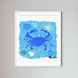 May include: A framed illustration of a blue crab with green and white seashells on a blue background. The artist's signature is in the bottom right corner.