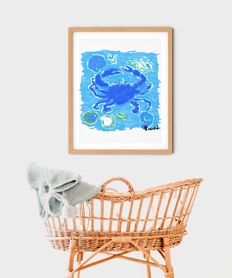 May include: A framed illustration of a blue crab with green and blue shells and seaweed on a light blue background. The artist's signature is in the bottom right corner.
