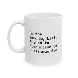 Op de afbeelding: Een witte keramische mok met een handvat aan de linkerkant. De mok is aan de voorzijde bedrukt met zwarte tekst die luidt: On the Naughty List: Pushed to Production on Christmas Eve. Het ontwerp is gecentreerd op het gladde, cilindrische oppervlak.
