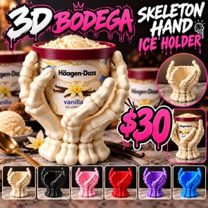 May include: A cream-colored skeleton hand ice holder designed to cradle a pint of Häagen-Dazs vanilla ice cream. The structure features articulated finger bones forming a cup shape. Additional color options include black, pink, red, purple, and blue.