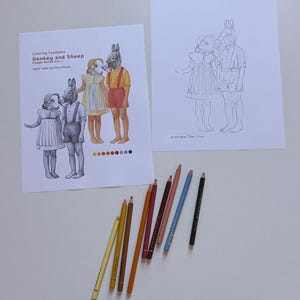 May include: Two sheets of paper featuring line art of a child with a sheep head and a child with a donkey head. One sheet shows colored examples with the text Coloring Examples Donkey and Sheep Couple Series Vol. 1. Eight colored pencils are arranged below.