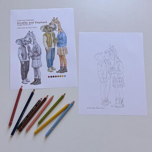 May include: Two sheets of paper featuring line art and colored illustrations of a giraffe and elephant couple. One sheet shows the characters in full color with the text "Coloring Examples Giraffe and Elephant Couple Series Vol. 1". Seven colored pencils are arranged below.