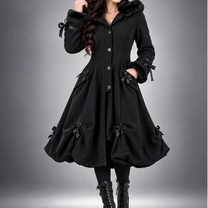May include: A black knee-length coat featuring a hood with faux fur trim, long sleeves with ribbon bow accents at the cuffs, a button-down front, and a flared skirt hem decorated with multiple black ribbon bows at the pockets and lower edge.