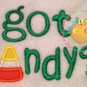 May include: Green embroidered text that reads "got candy?" with a yellow and orange candy corn graphic.