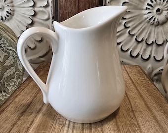 Small Porcelain Creamer or Milk pitcher with two stained Wooden Spoons Farmhouse Style Vignette grouping.