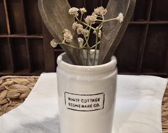 Half-Pint White Stoneware Crock with Crazing size 4.5"H x 3.0"D, includes two (2) stained wooden spoons and sprig of faux cream baby breathe