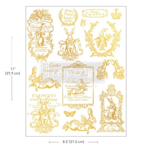 May include: A sheet of gold-colored Easter-themed transfers, measuring 8.5 inches (21.5 cm) wide and 11 inches (27.9 cm) tall. The sheet features various decorative elements, including rabbits, floral wreaths, and text such as "Happy Easter" and "Easter Greetings".