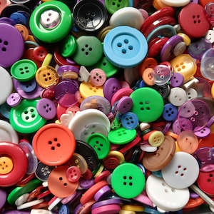 May include: A vibrant assortment of sewing buttons in various sizes and colors, including green, purple, red, and blue. The buttons have two or four holes and are made of plastic. A colorful collection for crafts and sewing projects.
