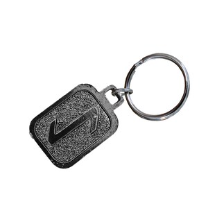 May include: A silver key chain with a black rectangular tag featuring the number "1" in a stylized font.