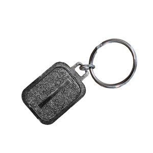 May include: A silver key chain with a rectangular tag featuring the number "1" in a textured, raised design.