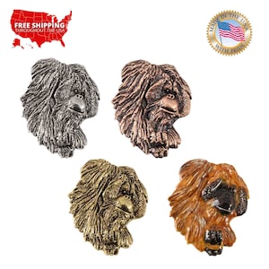 May include: Four different colored metal orangutan head sculptures. The sculptures are in silver, copper, gold, and bronze.