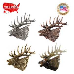 May include: Four different colored metal elk head sculptures. The elk heads are facing left and have antlers. The colors are silver, copper, gold, and brown.