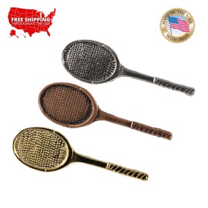 May include: Three miniature tennis rackets in different finishes: silver, copper, and gold. Each racket has a detailed design and a twisted handle.