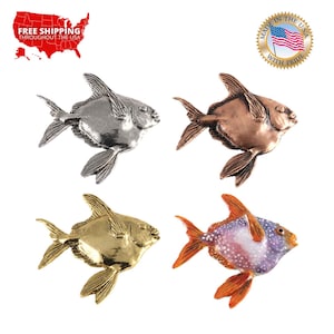 May include: Four different colored metal fish figurines. The fish are silver, copper, gold, and orange with white spots. The fish are all facing the right side of the image.