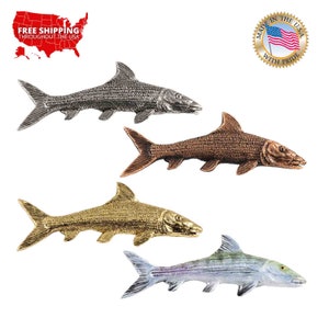 May include: Four metal fish figurines in different colours: silver, copper, gold, and white. Each fish has a detailed textured surface and a realistic shape.