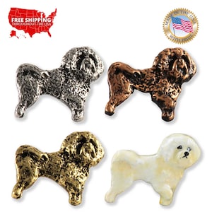 May include: Four miniature dog figurines in different finishes: silver, copper, gold, and white. The figurines are all of the same breed, a small, fluffy dog with a long, curly tail.
