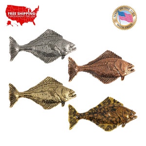 May include: Four halibut fish figurines in different finishes: silver, copper, gold, and a mottled gold and brown.  The figurines are all the same size and shape, and they are all facing to the right.  The figurines are made in the USA with pride.