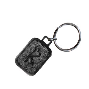 May include: A black metal keychain with a silver key ring. The keychain features a rectangular charm with a raised, textured design of the rune Algiz.