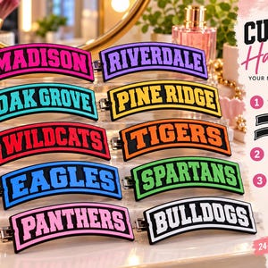 May include: A collection of ten curved hair clips featuring bold, block-letter text in various colors including pink, purple, teal, yellow, red, orange, blue, green, and white. Each clip displays a unique name such as Madison, Riverdale, and Tigers.