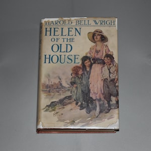 May include: A vintage book titled "Helen of the Old House" by Harold Bell Wright. The cover features an illustration of a woman in a hat with children. The book has a light blue title and a colorful illustration.