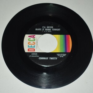 May include: Black vinyl 45 rpm record with a white label. The label has the text "I'll Never Make It Home Tonight" by Conway Twitty. The record is a Decca record with the number 32945.