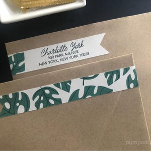 May include: A brown envelope with a white and green patterned label that says "Charlotte York, 930 Park Avenue, New York, New York 10028".