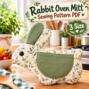 May include: A rabbit-shaped oven mitt sewing pattern PDF featuring a cream fabric with a green leaf and yellow flower print, solid green fabric accents, and a black button eye. The text reads Rabbit Oven Mitt Sewing Pattern PDF and 3 Size.