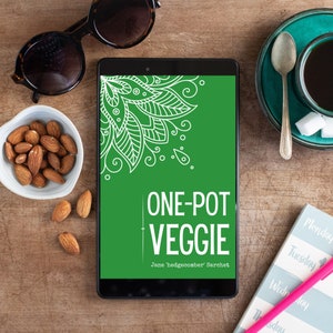 May include: A green and white cookbook with the title "One-Pot Veggie" by Jane Hedgecomber Sarchet. The cover features a white floral design.