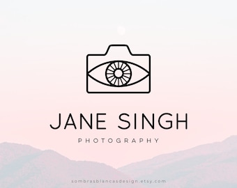 May include: Black and white line art logo of a camera with an eye inside. The text "JANE SINGH PHOTOGRAPHY" is below the logo.