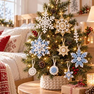May include: A small Christmas tree decorated with various crocheted ornaments, including white, light blue, and gold snowflakes, circular medallions, and star shapes, all featuring intricate yarn patterns and hanging loops.