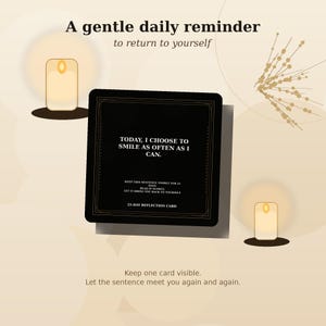 May include: A square black reflection card featuring white text that reads: TODAY, I CHOOSE TO SMILE AS OFTEN AS I CAN. KEEP THIS SENTENCE VISIBLE FOR 21 DAYS. READ IT SLOWLY. LET IT BRING YOU BACK TO YOURSELF. 21-DAY REFLECTION CARD. The card has a thin border.