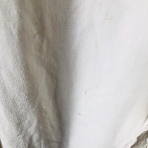 May include: White fabric with brown stains.