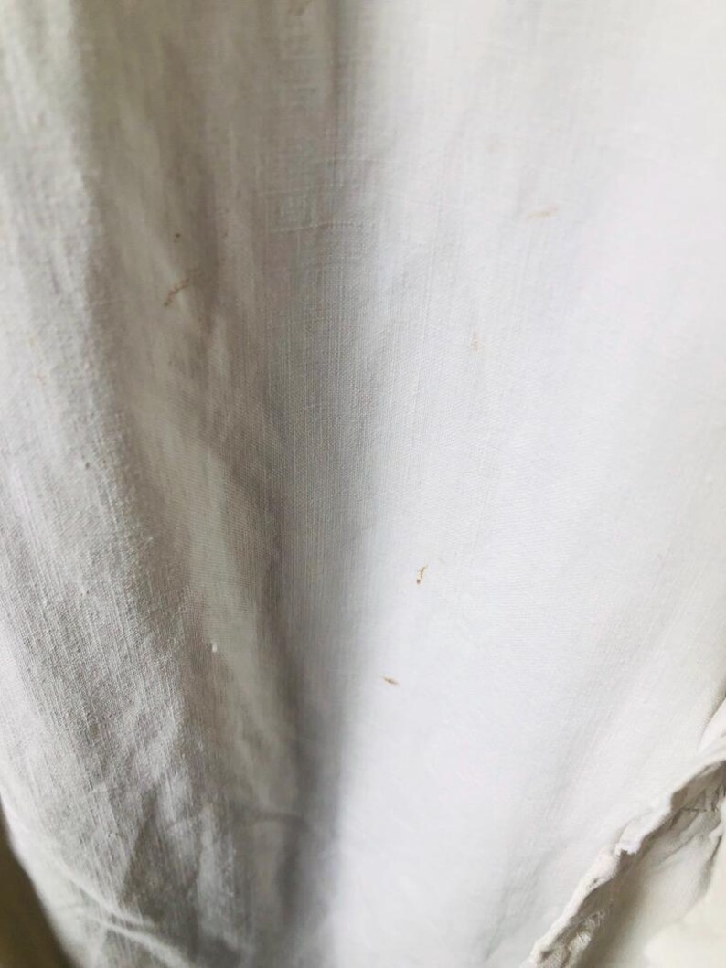 May include: White fabric with brown stains.