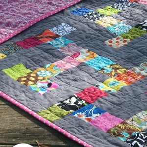 modern quilt made up of colorful scrappy squares