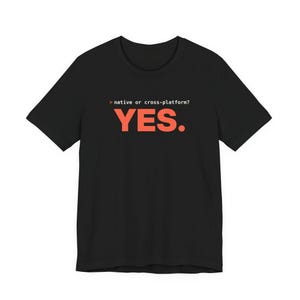 Puede incluir: Una camiseta negra de manga corta con texto blanco que dice > native or cross-platform? y la palabra YES. impresa en letras mayúsculas grandes, negritas y de color naranja, centrada en el pecho de la prenda.