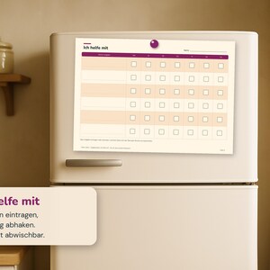 May include: A magnetic chore chart with a cream background and purple accents, featuring the text Ich helfe mit. The grid includes rows for tasks and columns for days of the week with checkboxes. A purple circular magnet holds the chart to a refrigerator.