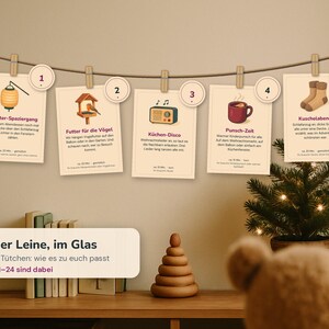 May include: A horizontal string with five cream-colored cards clipped to it, each numbered one through five. The cards feature illustrations of a lantern, bird feeder, radio, mug, and socks, with German text descriptions and a rectangular sign below.