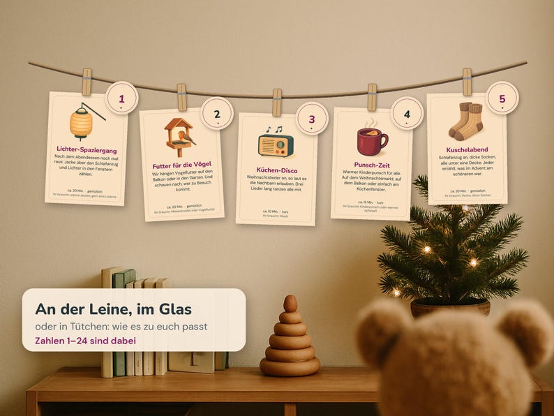 May include: A horizontal string with five cream-colored cards clipped to it, each numbered one through five. The cards feature illustrations of a lantern, bird feeder, radio, mug, and socks, with German text descriptions and a rectangular sign below.