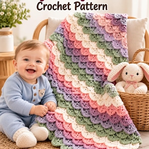 May include: A crochet blanket featuring a scalloped dragon scale pattern in alternating rows of sage green, cream, soft pink, and lavender. The text Dragon Baby Blanket Crochet Pattern is displayed at the top of the image.