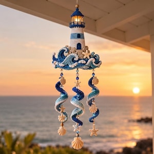 May include: A hanging crochet lighthouse ornament featuring a white and blue tower surrounded by crocheted waves, accented with small starfish and seashells. Three spiraling crochet strands hang below, decorated with beads and shells.