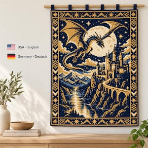 May include: A rectangular wall hanging featuring a cross-stitch pattern of a dragon flying over a castle, mountains, and a river under a large full moon. The design uses a dark blue and gold color palette with a decorative geometric border.