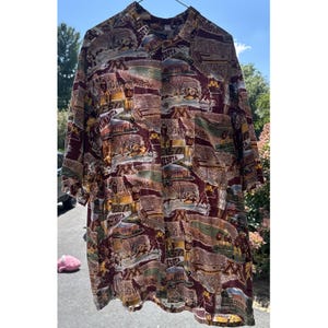 May include: A short-sleeved button-down shirt in maroon, gold, and white featuring an all-over print of Minnesota Golden Gophers sports imagery, including stadium scenes, the letter M logo, and mascot graphics repeated across the entire fabric.